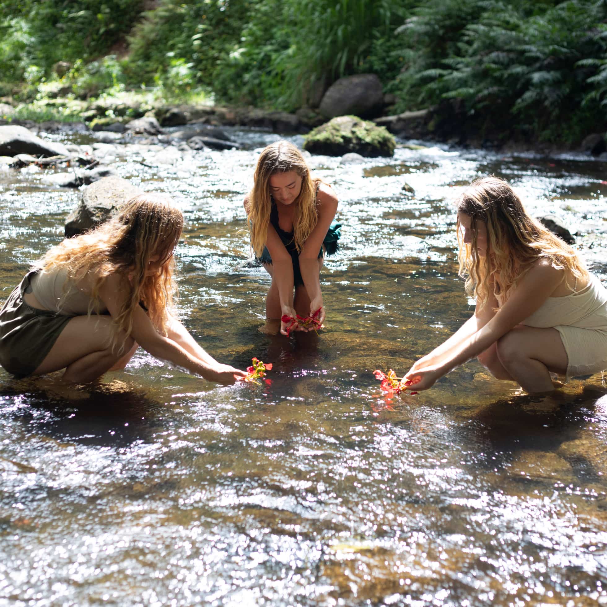 Meghan and two students wading in a river practicing the Amba Method.